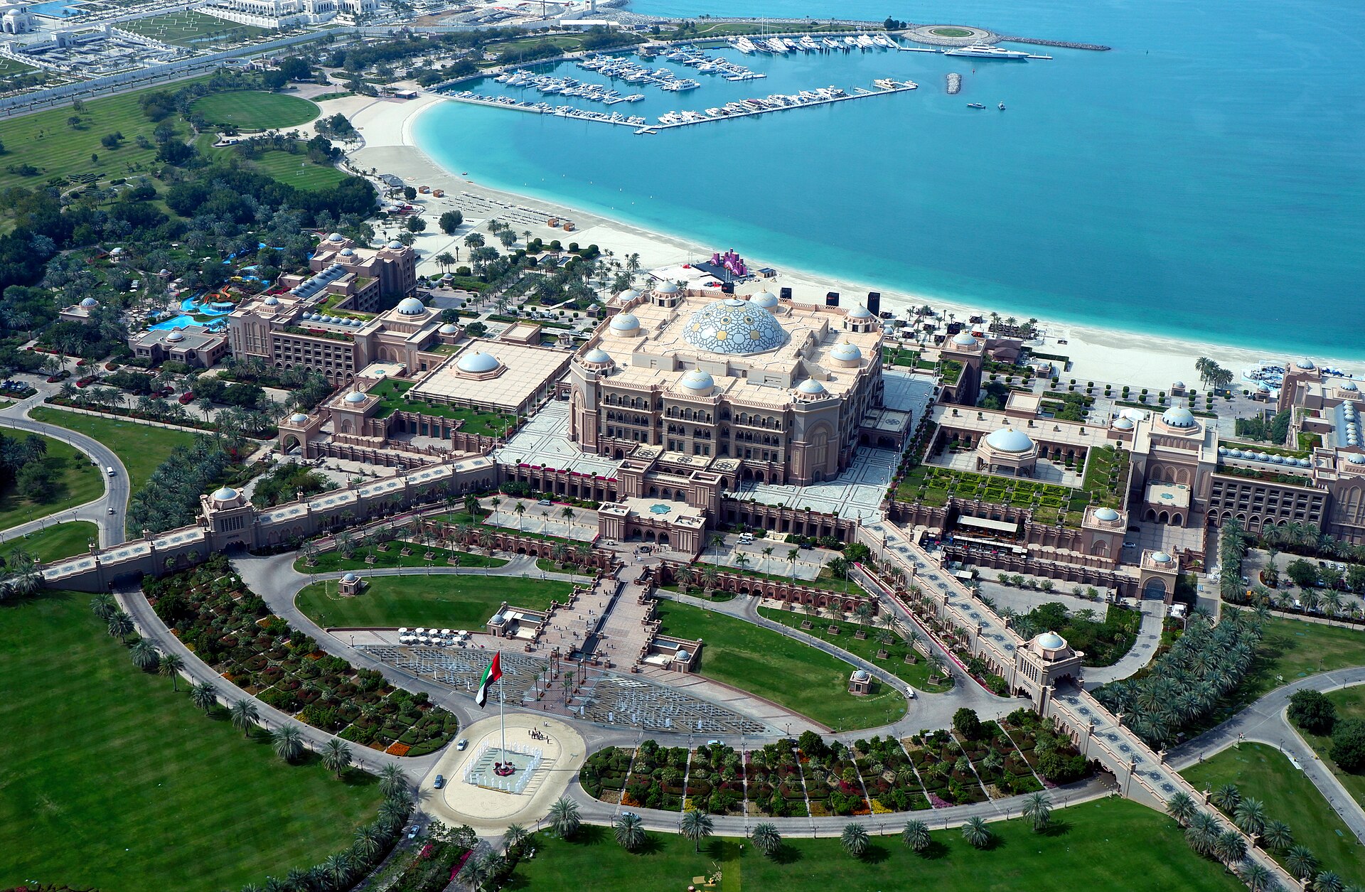 Aerial view of Emirates Palace and its gardens with the marina behind